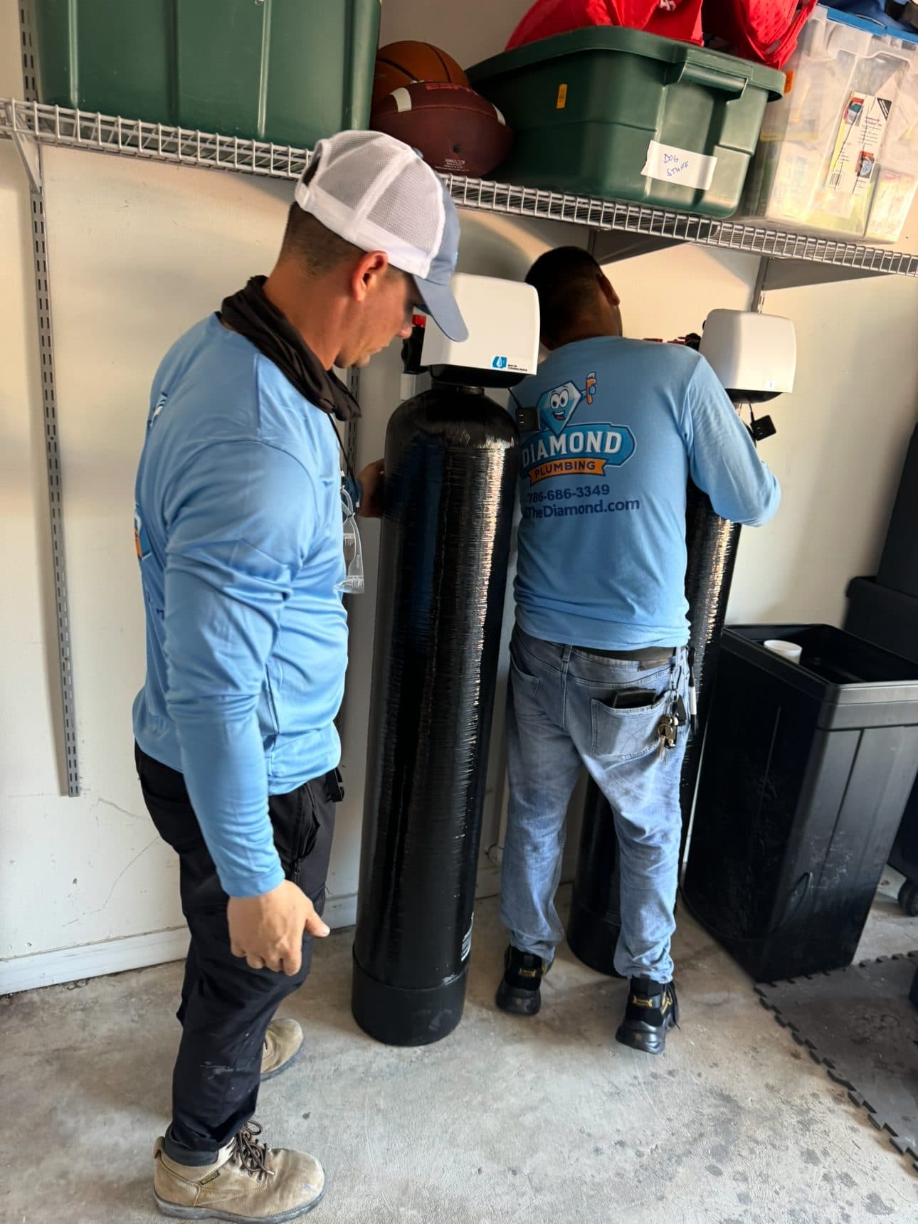 Diamond Plumbing technicians installing a whole-home water filtration system