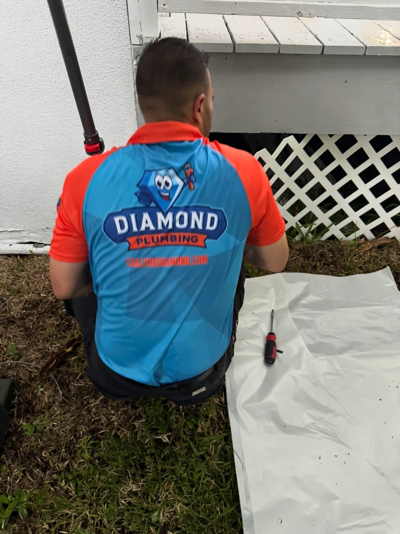 Diamond Plumbing technician on an exterior plumbing service call