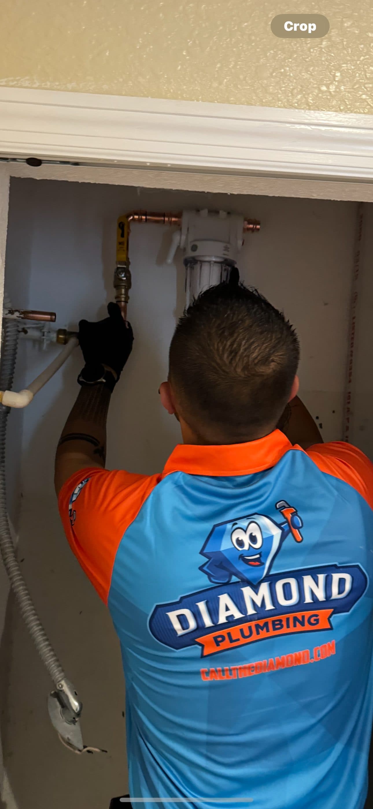 Diamond Plumbing technician completing an under-sink plumbing install